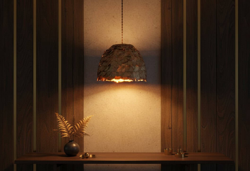 Lámpara artesanal Foresta iluminada con luz cálida, hecha con hojas naturales